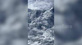 Massive avalanche crashes down Himalayan mountain as hikers rest nearby