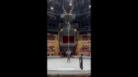 'No insurance!' - Daring circus artist balances himself atop a GIANT rod being held by his partner