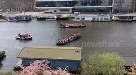 Amsterdam's canals filled with locals celebrating King's Day