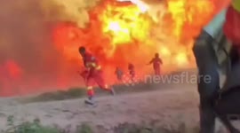 Terrifying footage shows Chinese firefighters narrowly escaping forest fire whirled around by strong winds