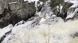 Winter Wild bedrock waterfall flowing in the wilderness of Ontario Canada
