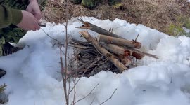 Bushcraft firesteel fire lighting to a blazing flame in the Ontario Canada wilderness