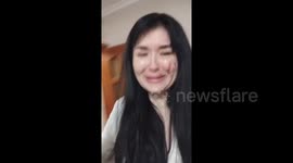 Woman covered in blood cries and shows aftermath of missile strike on Uman, Ukraine