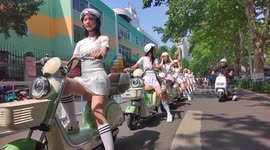 Girls riding scooters set to transport tourists to BBQ diners ahead of China's Labour Day