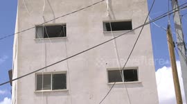 Palestinians inspect the damage following an Israeli military raid