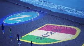 Projection of the Napoli logo and the three championships won in its history on the Posillipo beach. During the preparations for the celebration of the victory of the Italian Serie A championship and the third scudetto