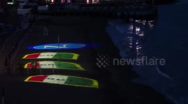 Projection of the Napoli logo and the three championships won in its history on the Posillipo beach. During the preparations for the celebration of the victory of the Italian Serie A championship and the third scudetto
