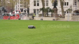 Robotic lawnmower cuts grass in Westminster's Parliament Square