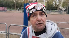 Royal Superfan John Loughrey comically introduces us to his and his friends Skye and Carol's campsite in the Mall where they are waiting to see Kings Coronation. John has nicknamed the place  Bucks House Hotel