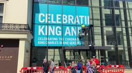 Workers install a huge coronation celebration outside Coutts