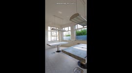 Urban explorer ventures into abandoned mortuary with coffins, working electricity, and autopsy tables
