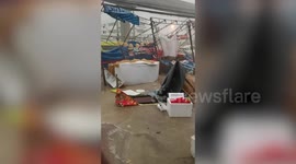 Summer storm destroys tents and stalls at market in Thailand