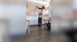 Compassionate teacher carries student's baby so she can focus during class