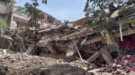 Rescuers scramble to save trapped people under collapsed building in western India