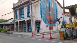 Thai street artist transforms old market into hip landmark with colourful mural