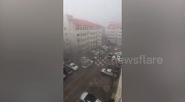 Empty cars slide from carpark as raging storm pummels Bangkok