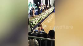 Proud indigenous tribesman wears native garment to take his diploma in graduation ceremony