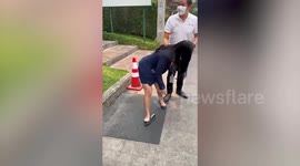 Careless office worker gets high heels stuck on manhole cover