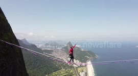 Slackline athlete crosses springy rope over dizzying high cliff in Brazil