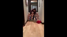 Tender-hearted boys stick by their triplet brother's side as he learns to walk using his posterior walker