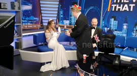 At a recording of the Talk TV show That Was The Woke That Was host Andre Walker surprises Lizzie Cundy with a Birthday Cake and trying to feed her