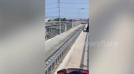 Driver gets stuck on narrow footbridge in Thailand