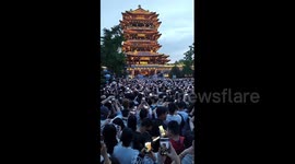 Massive crowds gather to see lighting of ancient building in northern China