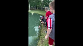 Watch this kid catch fish size of his arm using just his bare hands