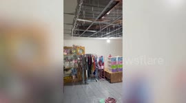Rain cascades through family's ceiling during storm in Thailand