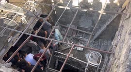 People inspect the site where three Palestinians were killed, during an Israeli raid in the West Bank city of Nablus.