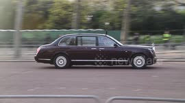 King Charles waves to fans camped along The Mall a couple of days before the coronation