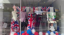 Charity shop celebrates Coronation with mannequins wearing masks of Royal family members
