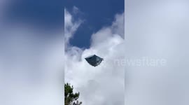 Upside down tent flies through the air carried away by wind in Indonesia