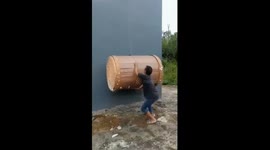 Close call: man narrowly avoids injury in drum-lifting mishap