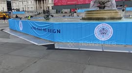 Trafalgar Square fountains draped in coronation banners on eve of coronation