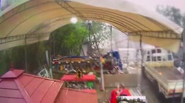 Storm batters tent outside building site in Thailand