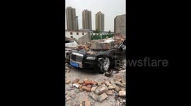 Wall collapse destroys £340000 worth of luxury cars