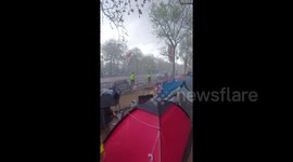 The rain of King Charles? Royal fans camp out during downpour before coronation