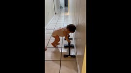 11-month-old baby tries catching up to her gymnast siblings by doing a handstand
