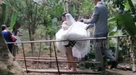 Bride treks barefoot with groom and entourage to celebrate wedding reception at home
