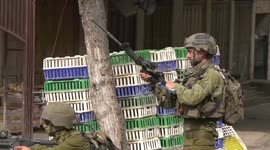 Israeli forces take position during clashes with Palestinian protesters, in the West Bank city of Hebron