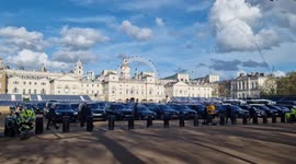 International guests are escorted by police to pre-coronation reception at Buckingham Palace