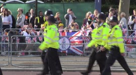 Royal fans camped out ahead of King's Coronation applaud Met Police officers as they walk down The Mall