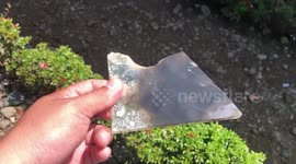 Father watches rare hybrid solar eclipse using broken glass