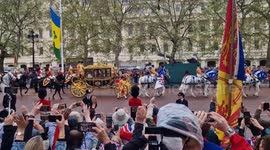 Crowds cheers as King Charles and Queen Consort Camilla travel along the Mall
