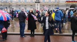Rain pours down on those outside Buckingham Palace after the Coronation has finished