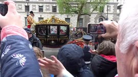 The royal family's procession through Whitehall during King Charles III's coronation is met with cheers from the crowds
