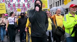 Anti-monarchy protesters stream past camera near Buckingham Palace on coronation day