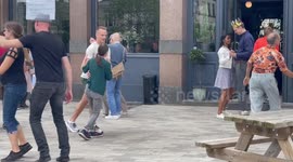 People swing in Coronation street party in north London