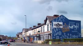 Coronation Mural on the side of a Terraced block of houses in Darwen created by Crown Paints caught on Dash Cam